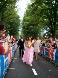 the Giro trophy is carried between rows of adoring fans